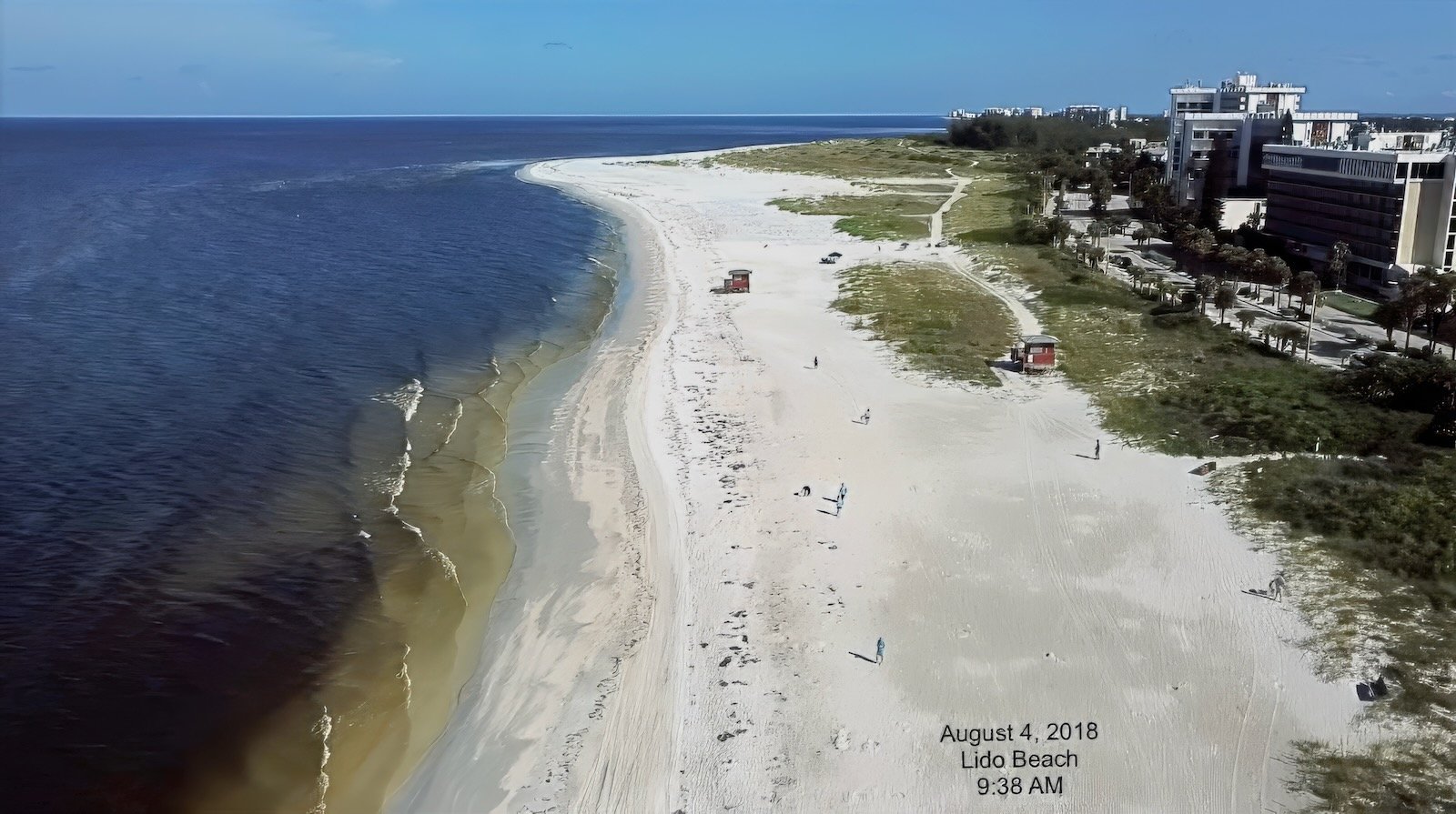 Aerial image of Longboat Key with dark Red Tide waters lining the shore