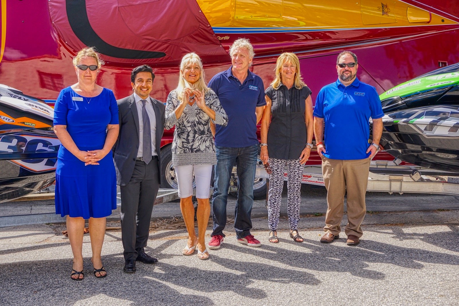 Steve Curtis, powerboat racing legend, stands with prominent P1 and Suncoast Charities for Children event organizers