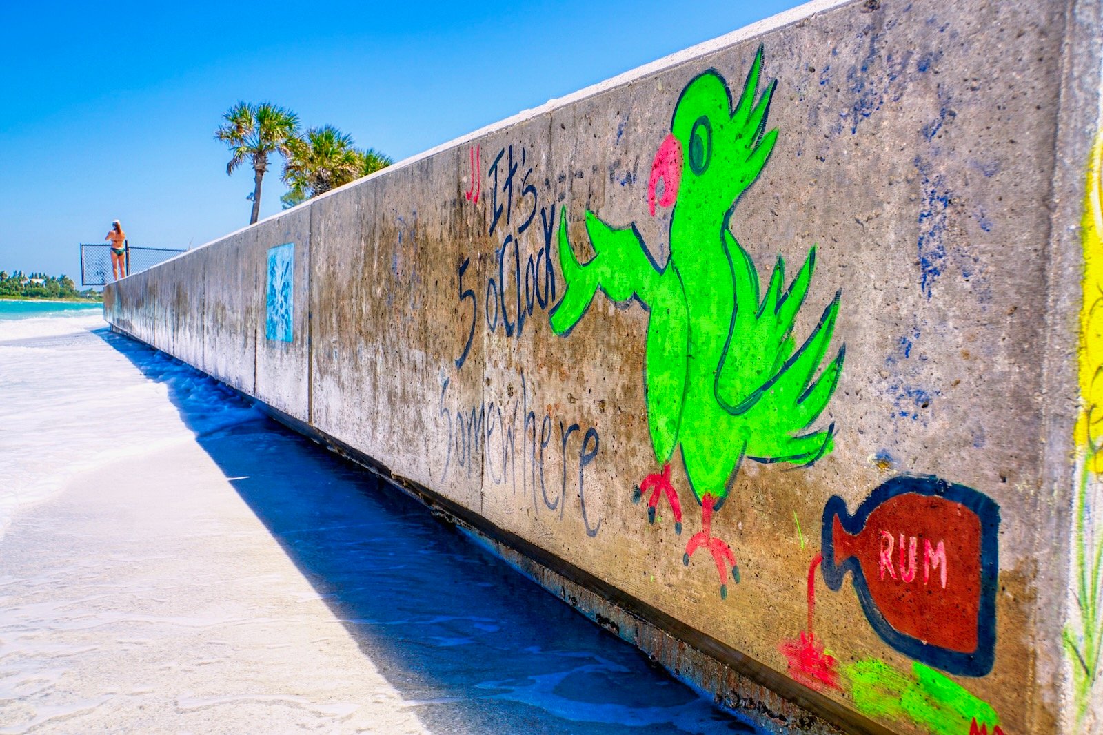 "It's 5 o'clock somewhere" greets visitors to the North Lido "mermaid wall," looking across New Pass to Longboat Key