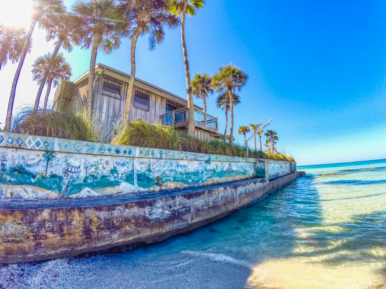 Iconic seawall & wood-framed house at Point of Rocks Siesta Key