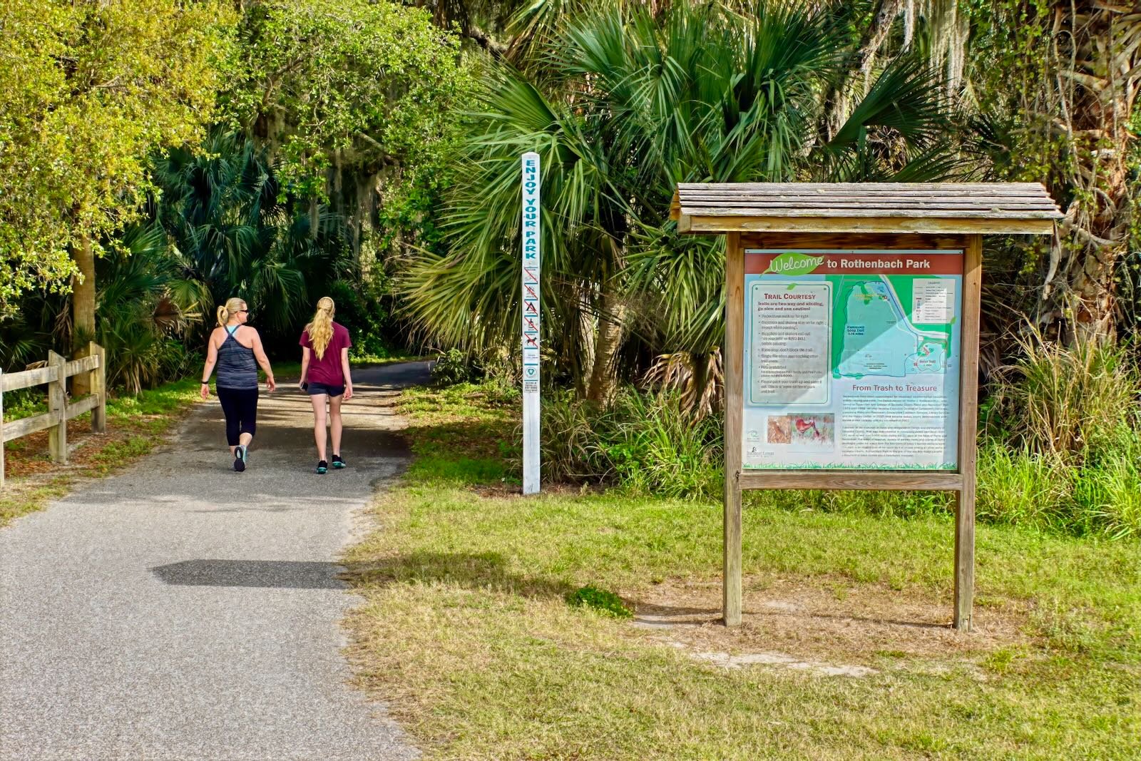 mother & daughter stroll the canopied trail at Rothenbach Park Sarasota